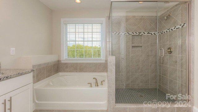 bathroom with vanity and plus walk in shower