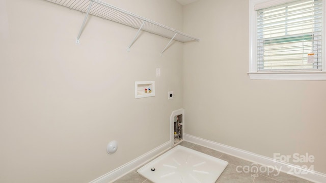 clothes washing area with washer hookup, hookup for an electric dryer, and tile patterned floors