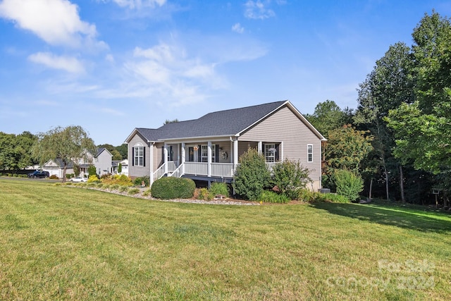 ranch-style house featuring a front yard and covered porch