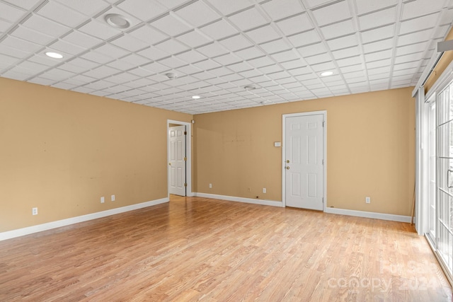 unfurnished room featuring a paneled ceiling and light hardwood / wood-style floors