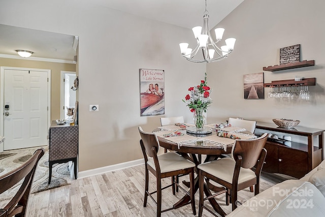 dining room featuring crown molding, a chandelier, and light hardwood / wood-style floors