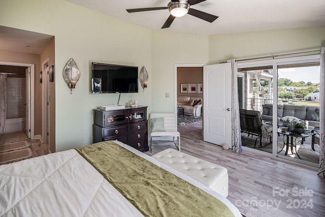 bedroom featuring ensuite bath, light wood-type flooring, lofted ceiling, access to exterior, and ceiling fan