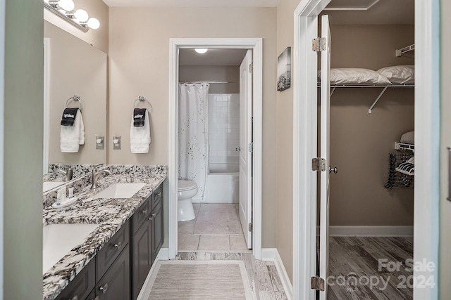 full bathroom with vanity, toilet, wood-type flooring, and shower / bath combo