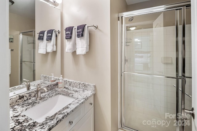 bathroom with an enclosed shower and vanity