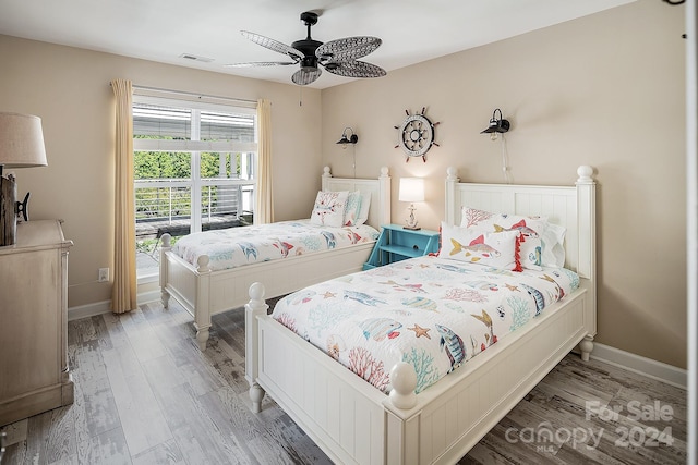 bedroom with ceiling fan and hardwood / wood-style flooring