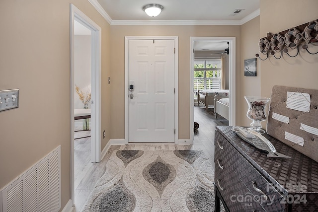 entryway featuring ceiling fan, ornamental molding, and light hardwood / wood-style floors