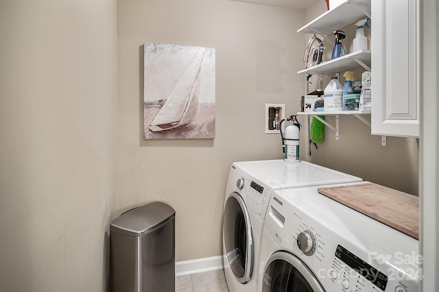 washroom with washing machine and clothes dryer and light tile patterned flooring