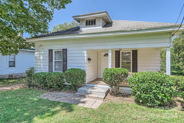 bungalow with a porch and a front yard