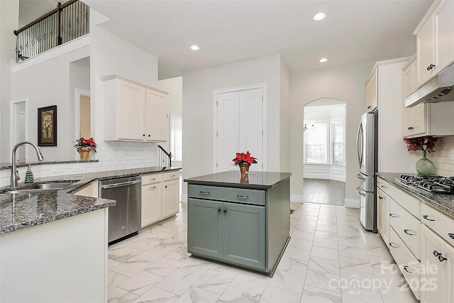 kitchen with sink, stainless steel appliances, tasteful backsplash, green cabinetry, and white cabinets