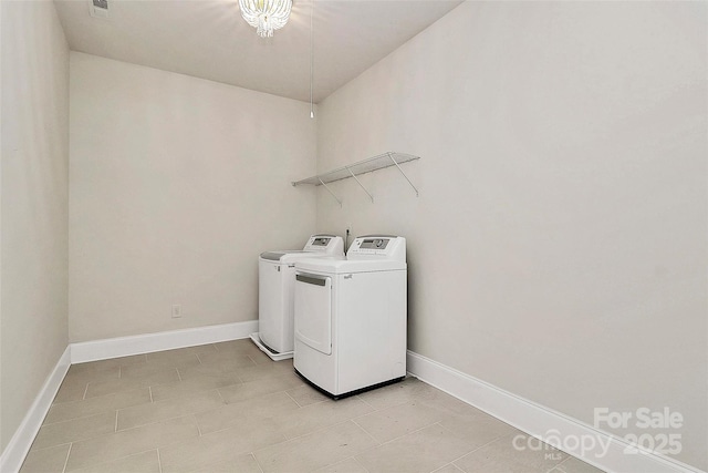 washroom featuring light tile patterned floors and washer and clothes dryer