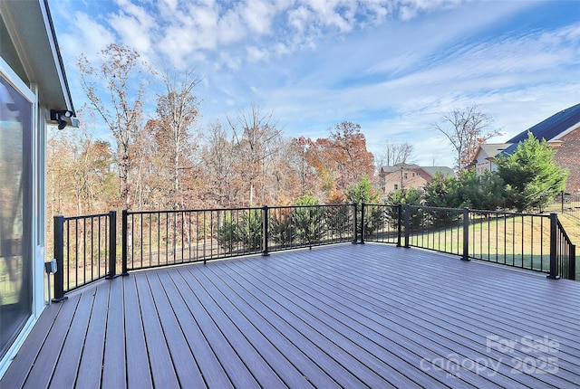 wooden terrace featuring a lawn