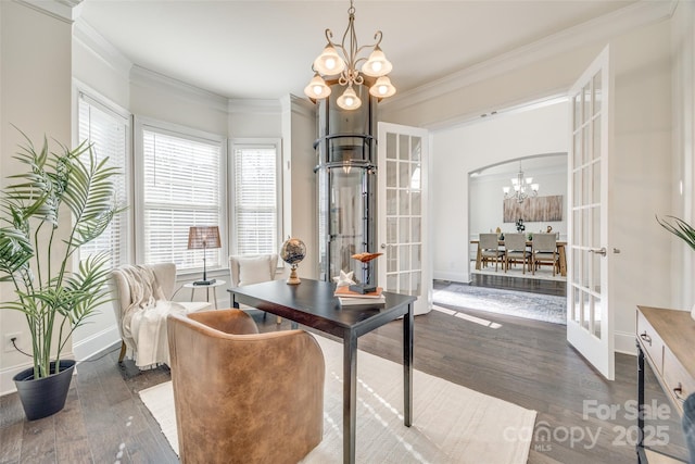 office space with arched walkways, french doors, crown molding, a notable chandelier, and wood finished floors