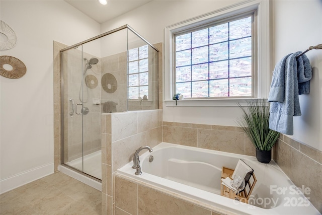 bathroom with a stall shower and a bath