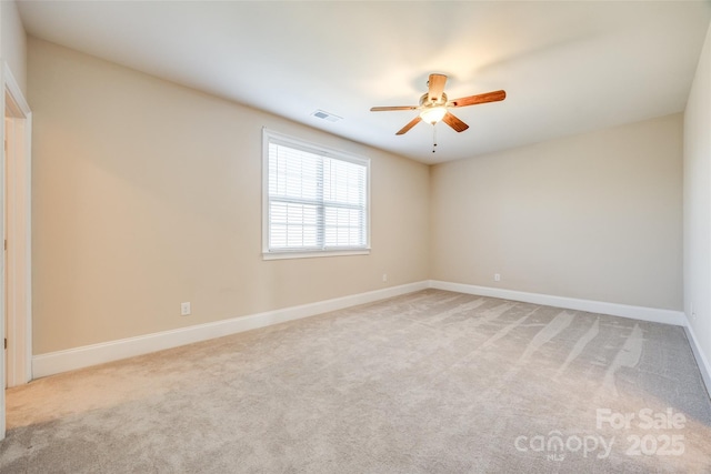 unfurnished room featuring baseboards, a ceiling fan, visible vents, and light colored carpet