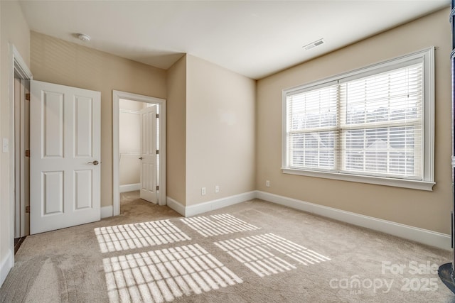 unfurnished bedroom with baseboards, visible vents, and carpet flooring