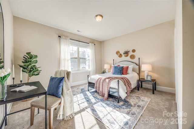 carpeted bedroom with visible vents and baseboards