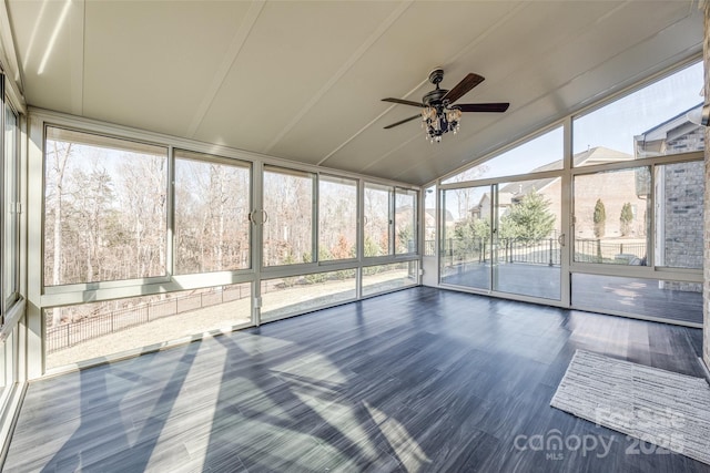 unfurnished sunroom with ceiling fan and vaulted ceiling