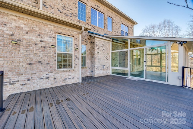 wooden terrace featuring a sunroom