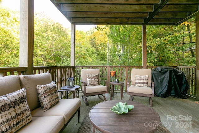 wooden deck with grilling area and an outdoor hangout area