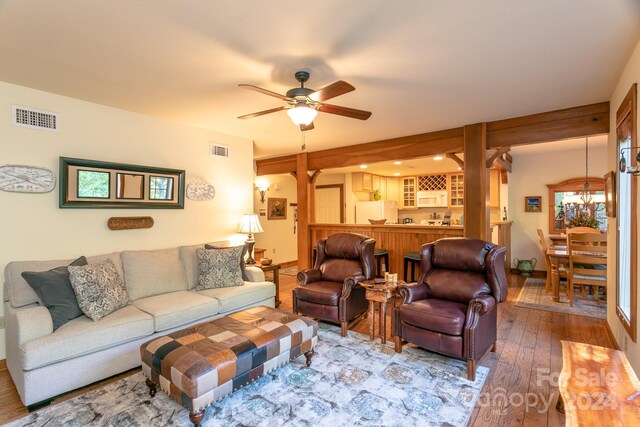 living room with ceiling fan and wood-type flooring