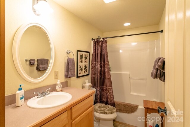 full bathroom with shower / bath combination with curtain, toilet, and vanity