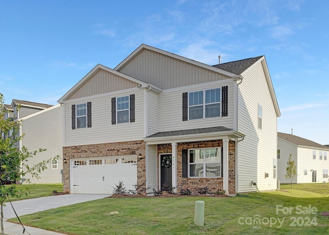 view of front of property featuring a garage and a front lawn