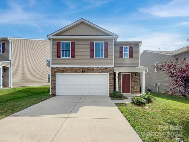 view of front of property featuring a garage and a front lawn