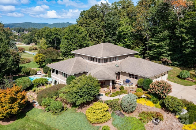 drone / aerial view with a wooded view