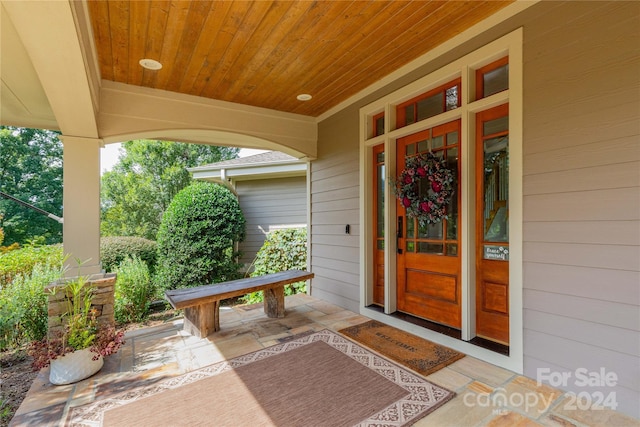 view of exterior entry with covered porch