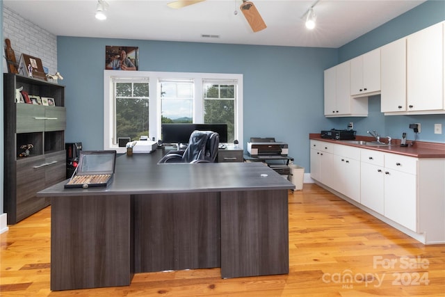 kitchen featuring white cabinets, light hardwood / wood-style floors, sink, track lighting, and ceiling fan