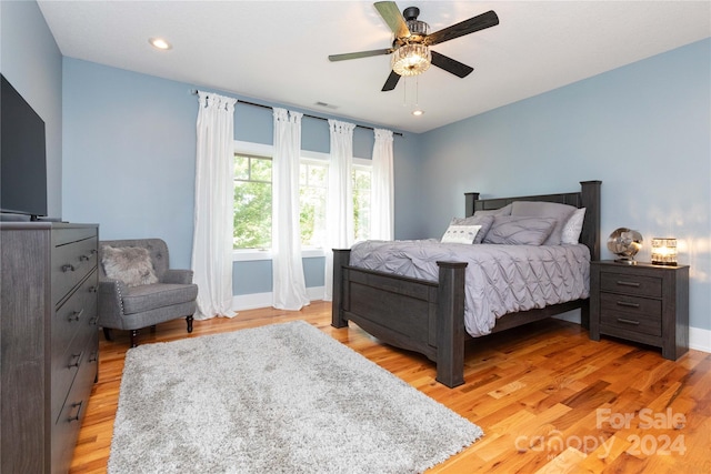 bedroom with light wood-type flooring and ceiling fan