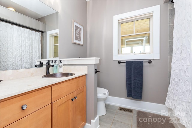 bathroom with vanity, toilet, a shower with curtain, and tile patterned floors