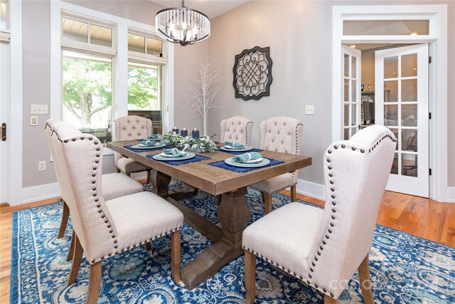 dining space featuring a notable chandelier and light hardwood / wood-style flooring