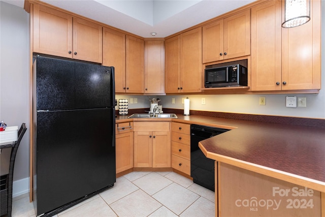 kitchen with black appliances, sink, and light tile patterned floors