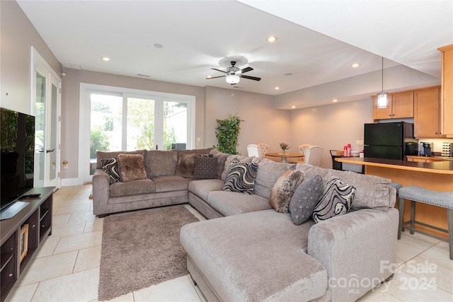 living room featuring ceiling fan and light tile patterned floors