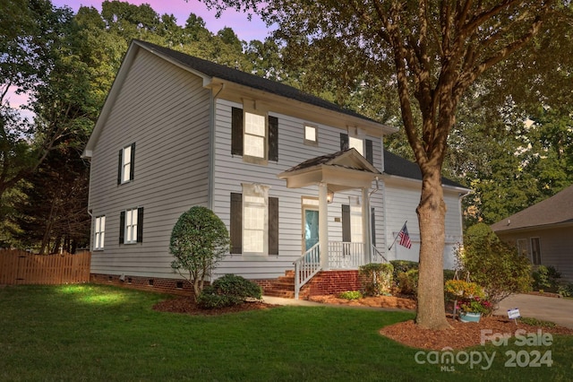 colonial-style house featuring a yard