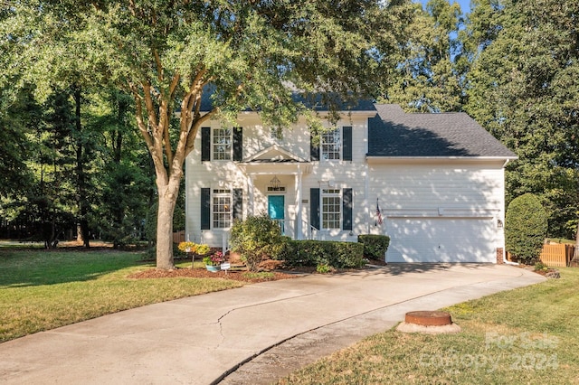 view of front of house with a front yard and a garage