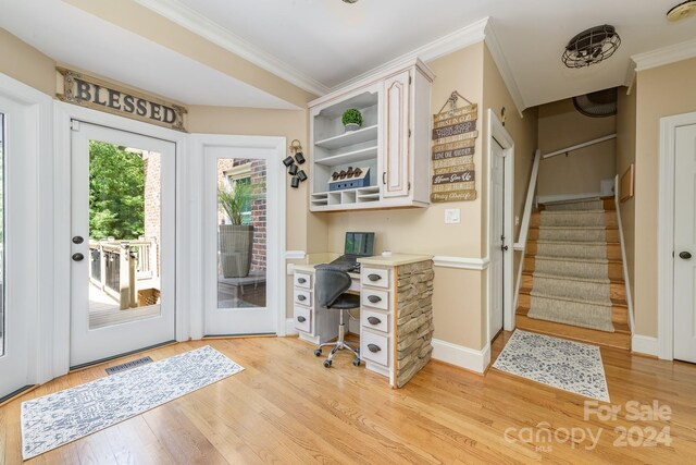 interior space featuring crown molding and light hardwood / wood-style floors