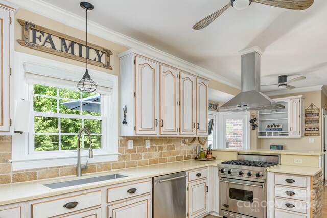 kitchen with appliances with stainless steel finishes, ceiling fan, island exhaust hood, and ornamental molding