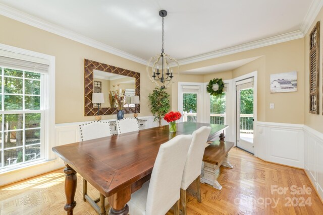 dining area with a chandelier and crown molding