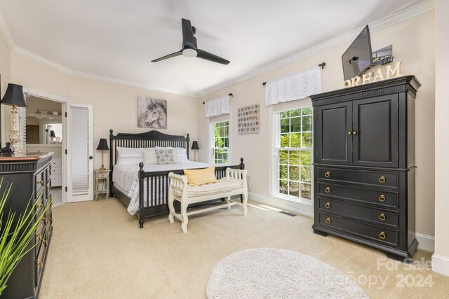 bedroom with ceiling fan, light carpet, and ornamental molding