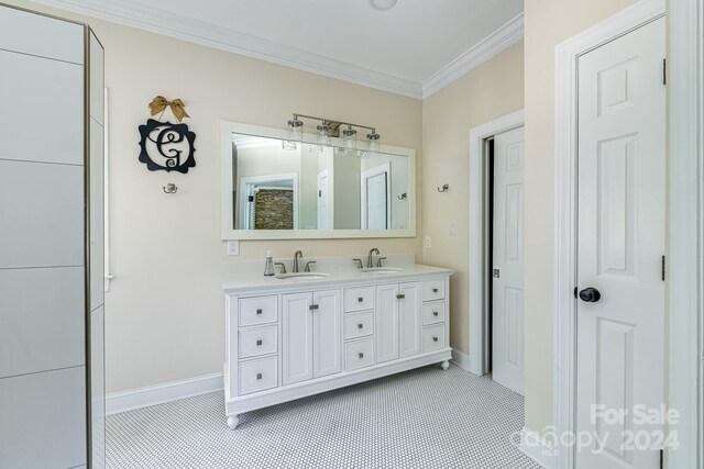 bathroom featuring tile patterned flooring, crown molding, and vanity