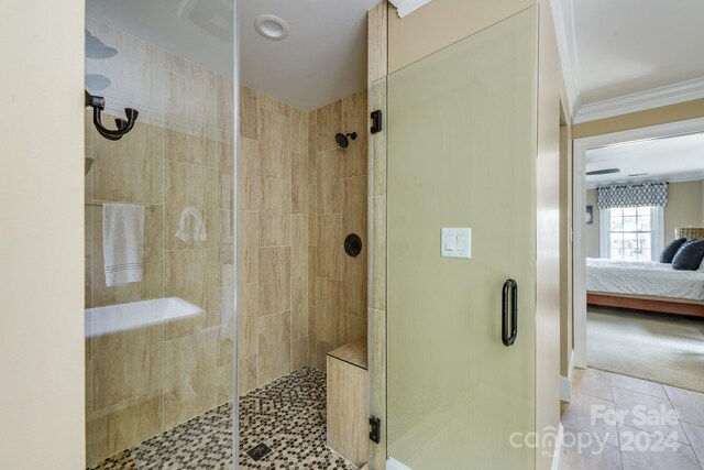 bathroom with crown molding, an enclosed shower, and tile patterned floors