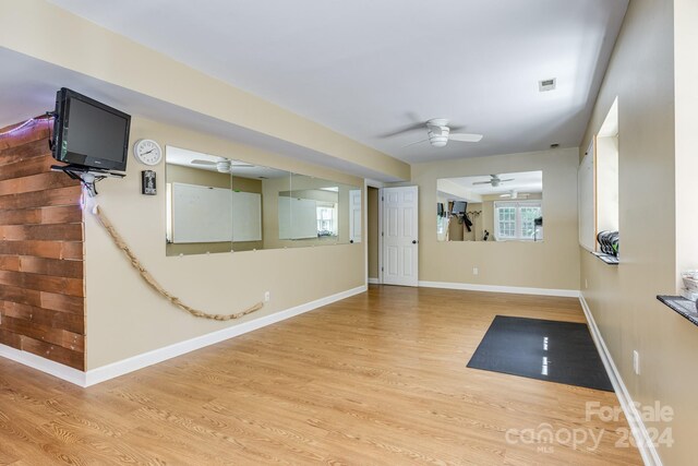 workout area featuring ceiling fan and hardwood / wood-style flooring