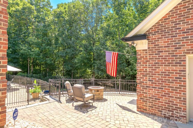 view of patio / terrace with an outdoor fire pit