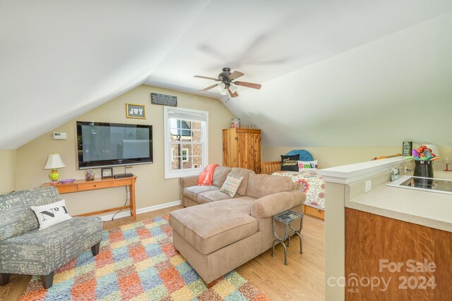 living room featuring light wood-type flooring, lofted ceiling, and ceiling fan