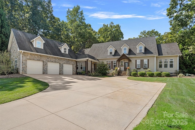 new england style home featuring a front yard and a garage