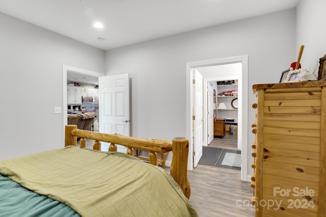 bedroom featuring light hardwood / wood-style flooring and a spacious closet