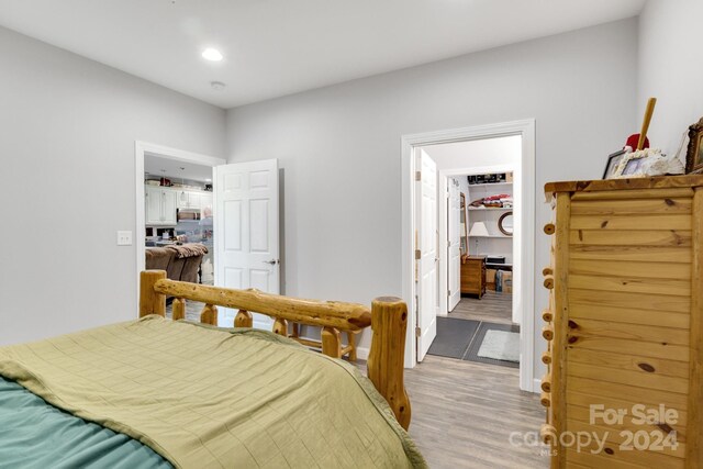 202 Ivy Ct, Morganton, NC 28655 - bedroom with a walk in closet, light wood-type flooring, recessed lighting, and a closet