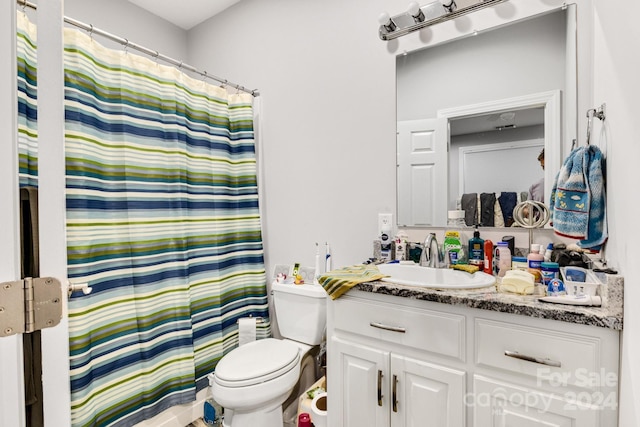 bathroom with vanity, toilet, and a shower with curtain